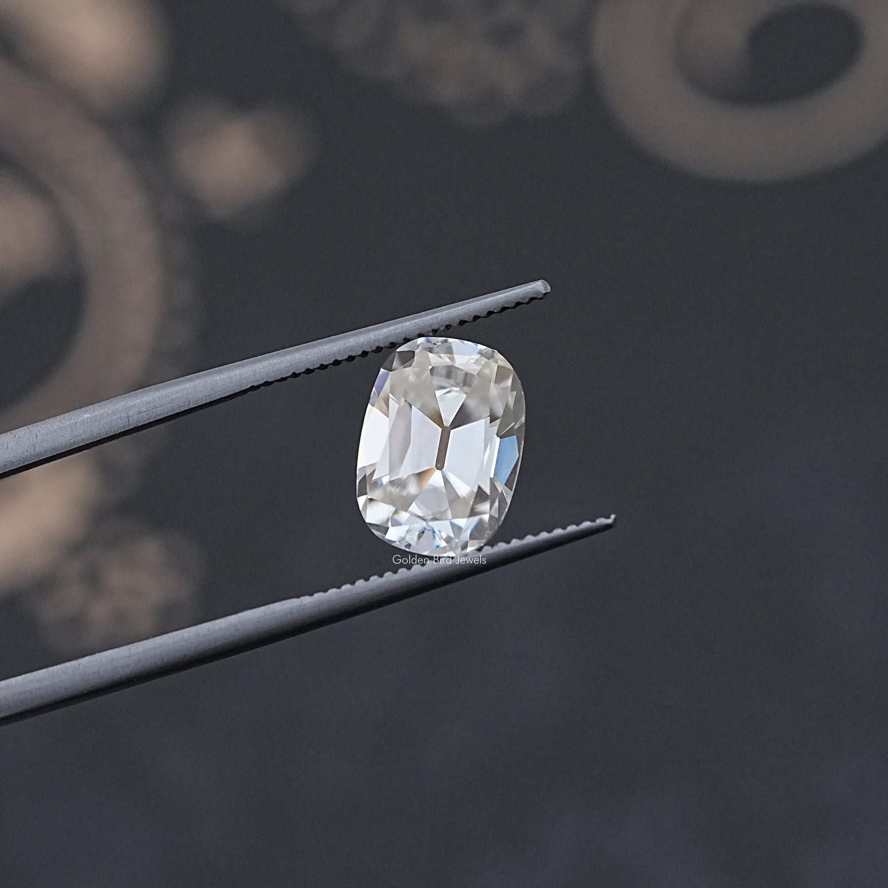 In Tweezer View Of Old Mine Cushion Cut Moissanite Loose Stone
