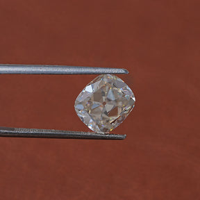 In Tweezer View Of Off White Old Mine Cushion Cut Loose