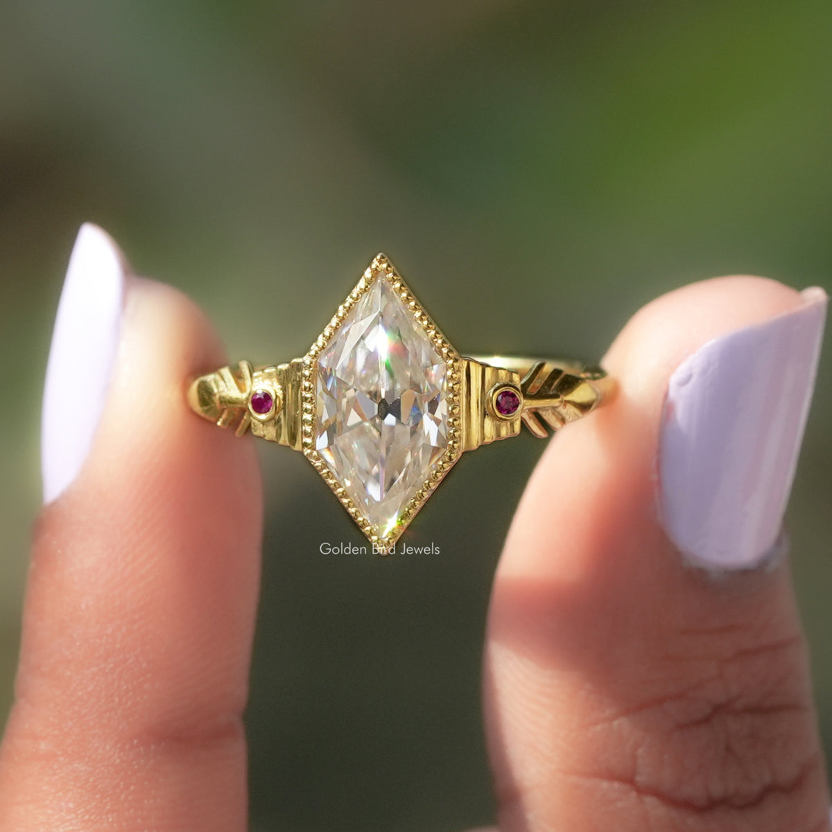 Two fingers holding the old mine dutch marquise cut moissanite ring