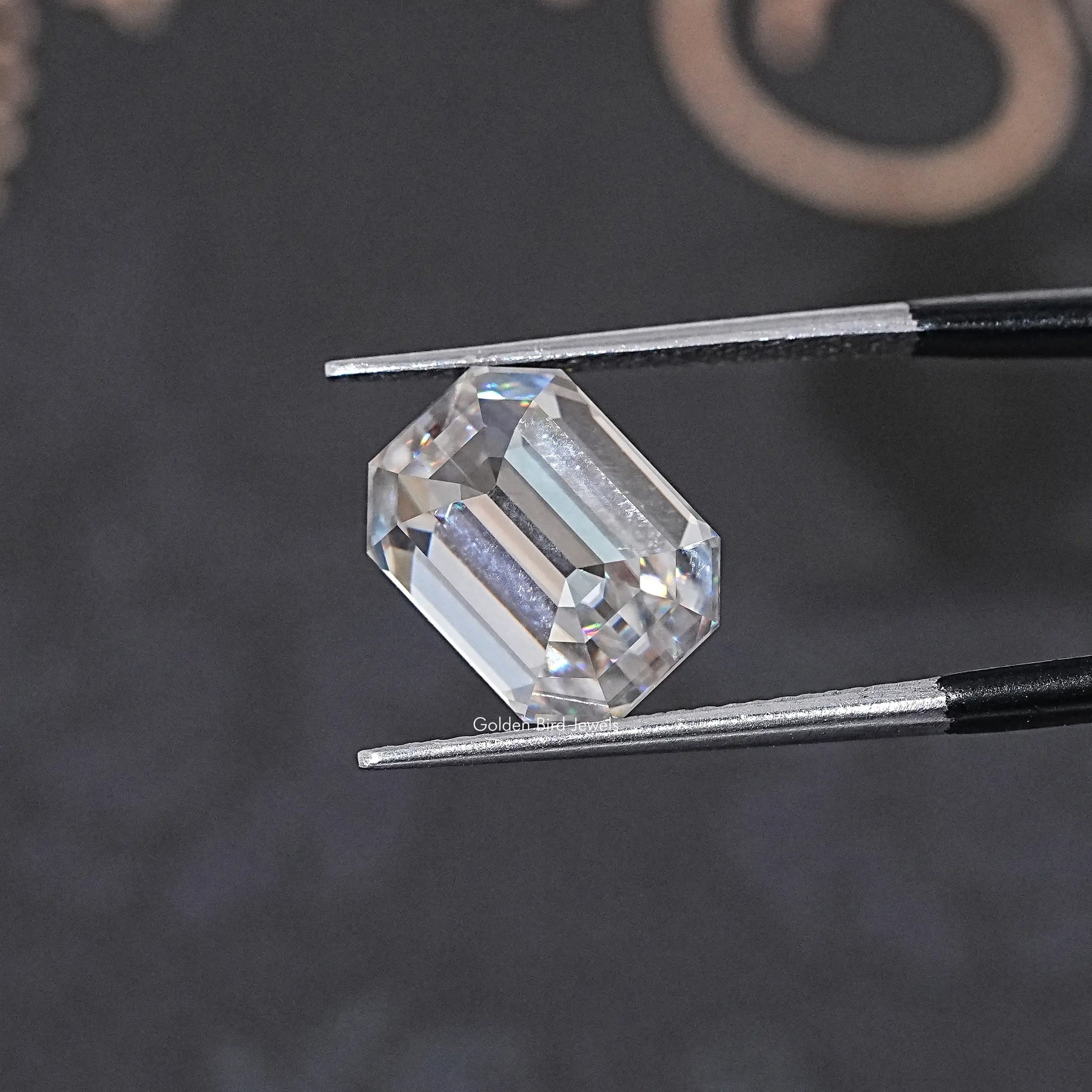 In Tweezer View Of Old Mine Emerald Cut Loose Moissanite
