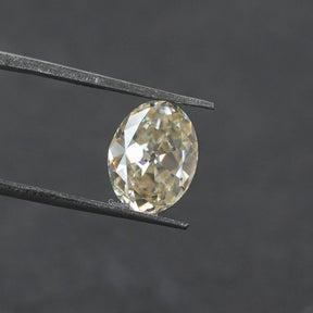 Tweezer view of White Old Mine Cushion Cut Loose moissanite 