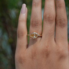 Close-Up View of  Pear Cut Moissanite Engagement Ring In Yellow Gold