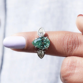In finger front View of Blue Old Mine Pear Cut Moissanite Ring In White Gold