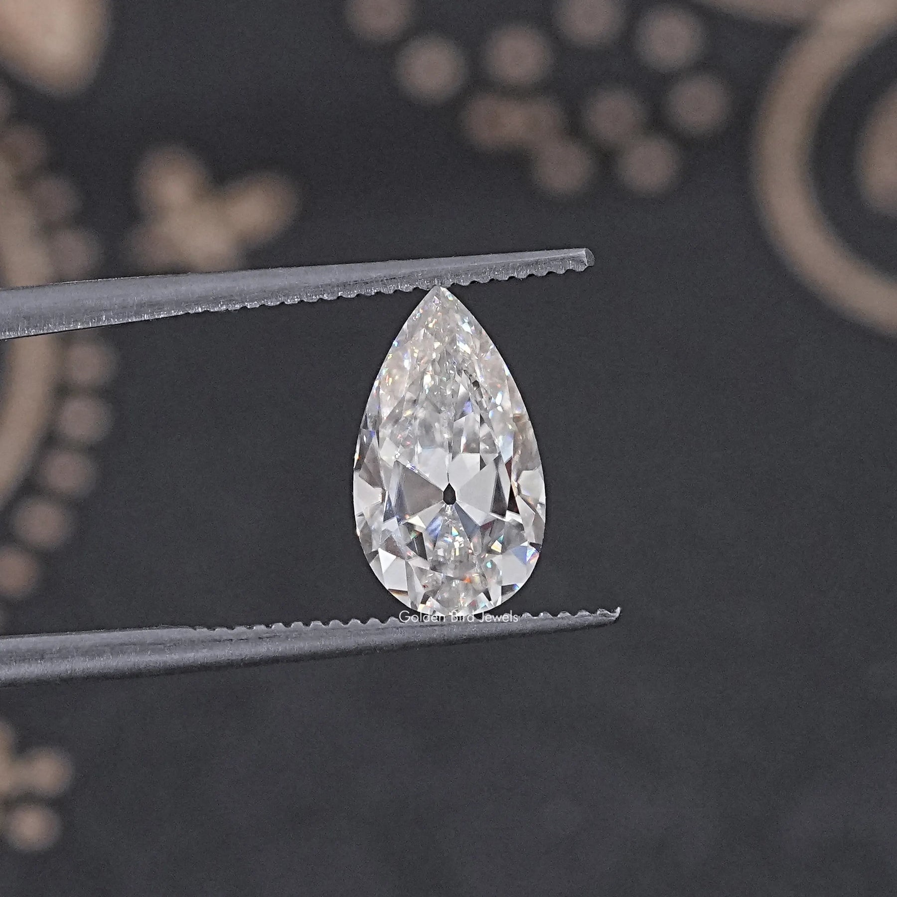 In Tweezer View Of Old Mine Pear Cut Loose Moissanite Stone