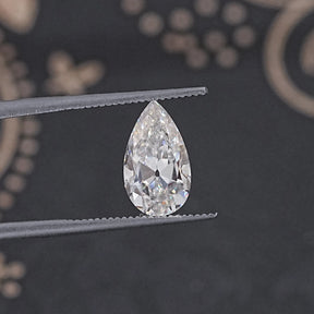 In Tweezer View Of Old Mine Pear Cut Loose Moissanite Stone