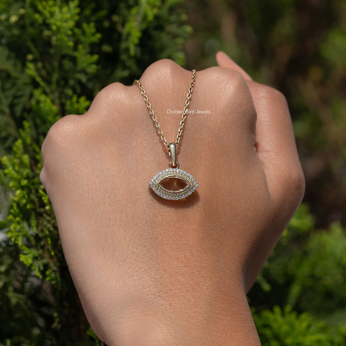 In hand showing a view of moissanite pendant