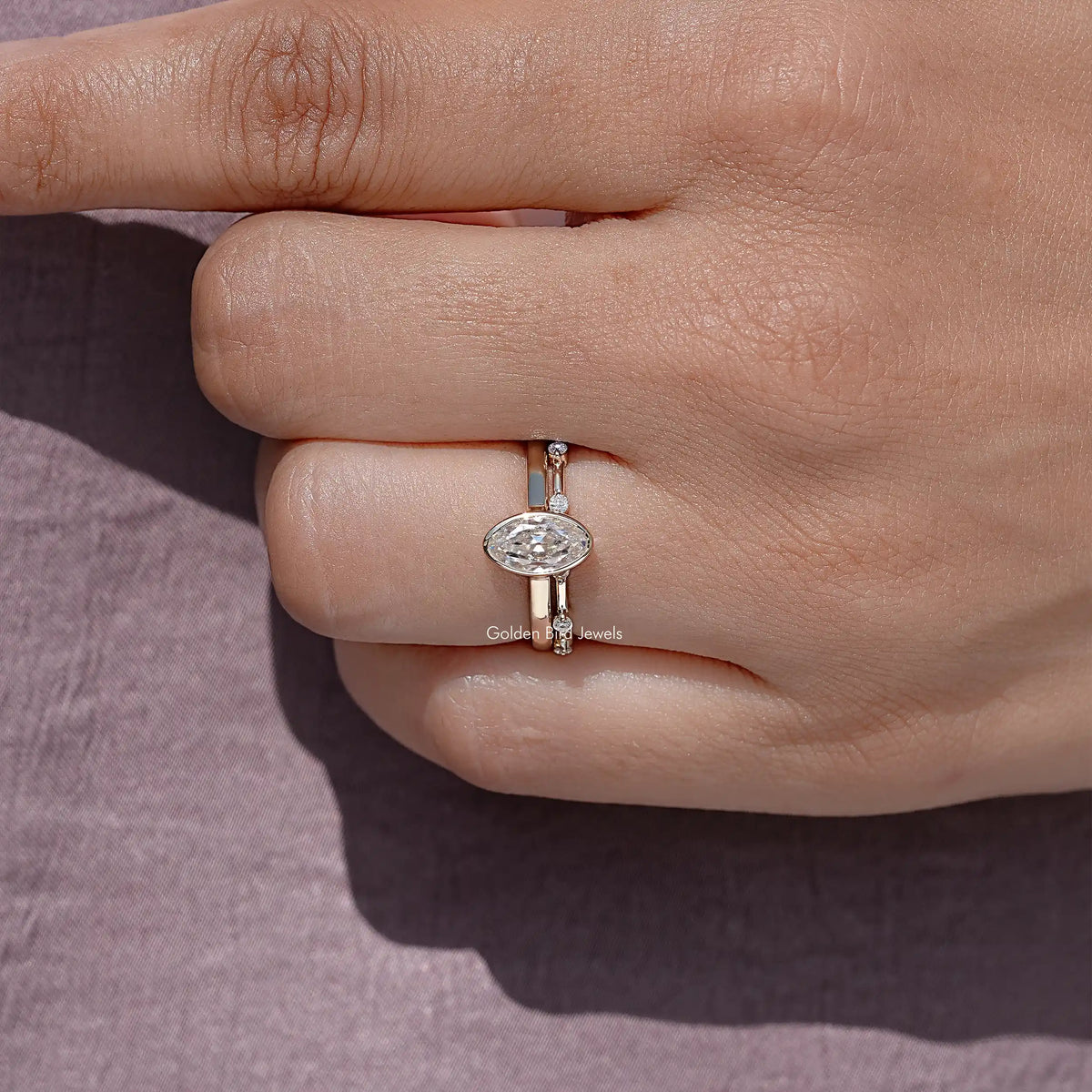 Top view of oval moissanite solitaire ring set with small side stones