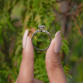 Back View of Oval And Round Cut Lab Grown Diamond Ring In two fingers