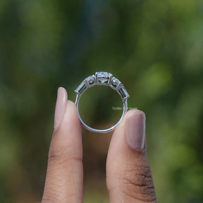 Back View of Oval And Tapered Baguette Cut Diamond Five Stone Ring In two fingers