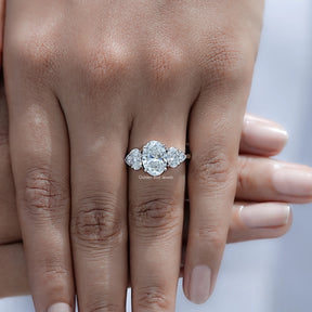 Top view of Oval And Trillion Diamond Five Stone Ring Held in Finger