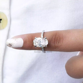 In finger front View of Oval And Baguette Cut Moissanite Ring