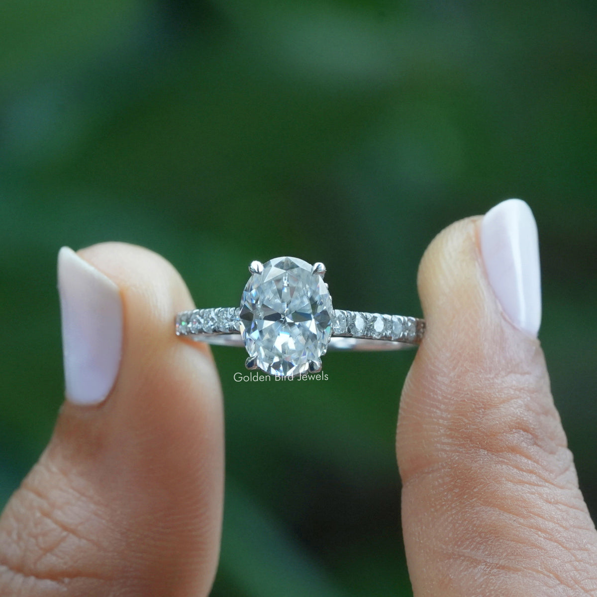 Front View Of Oval Cut Engagement Ring In Two Fingers