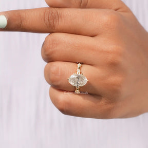 Detailed View Of Oval Cut Moissanite Accent Stone Ring In Yellow Gold