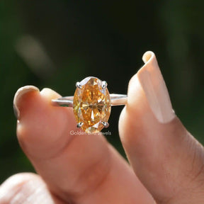 Front View of Oval Cut Moissanite Solitaire Engagement Ring In two Fingers