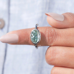 In finger front View of Bezel Set Oval Cut Moissanite Engagement Ring