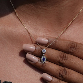 Close-up view of Oval Cut Gemstone Halo Pendant In Yellow gold