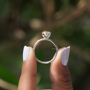 Back View of Oval Cut Diamond Solitaire Ring In two fingers