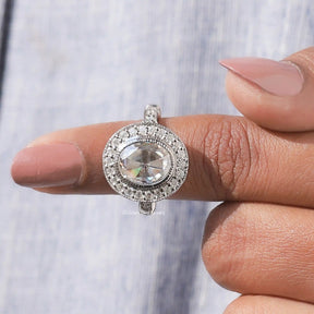 In finger front View of Oval Cut Bezel Set Moissanite Halo Engagement Ring