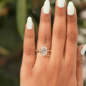 View of Oval Cut Moissanite Accent Stone Ring In Yellow Gold