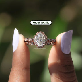 Two fingers holding the Oval Cut Moissanite Halo Wedding Ring