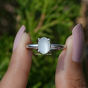 Front View of Oval Moonstone Gemstone Solitaire Ring In two Fingers