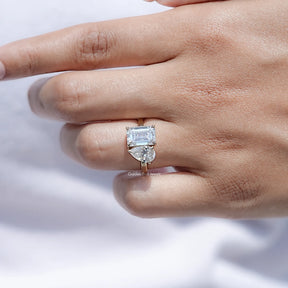 View of Pear And Emerald Cut Moissanite Solitaire Ring in prongs setting 