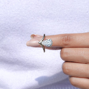 In finger front View of Pear Cut Curved Band Solitaire Ring In Yellow Gold