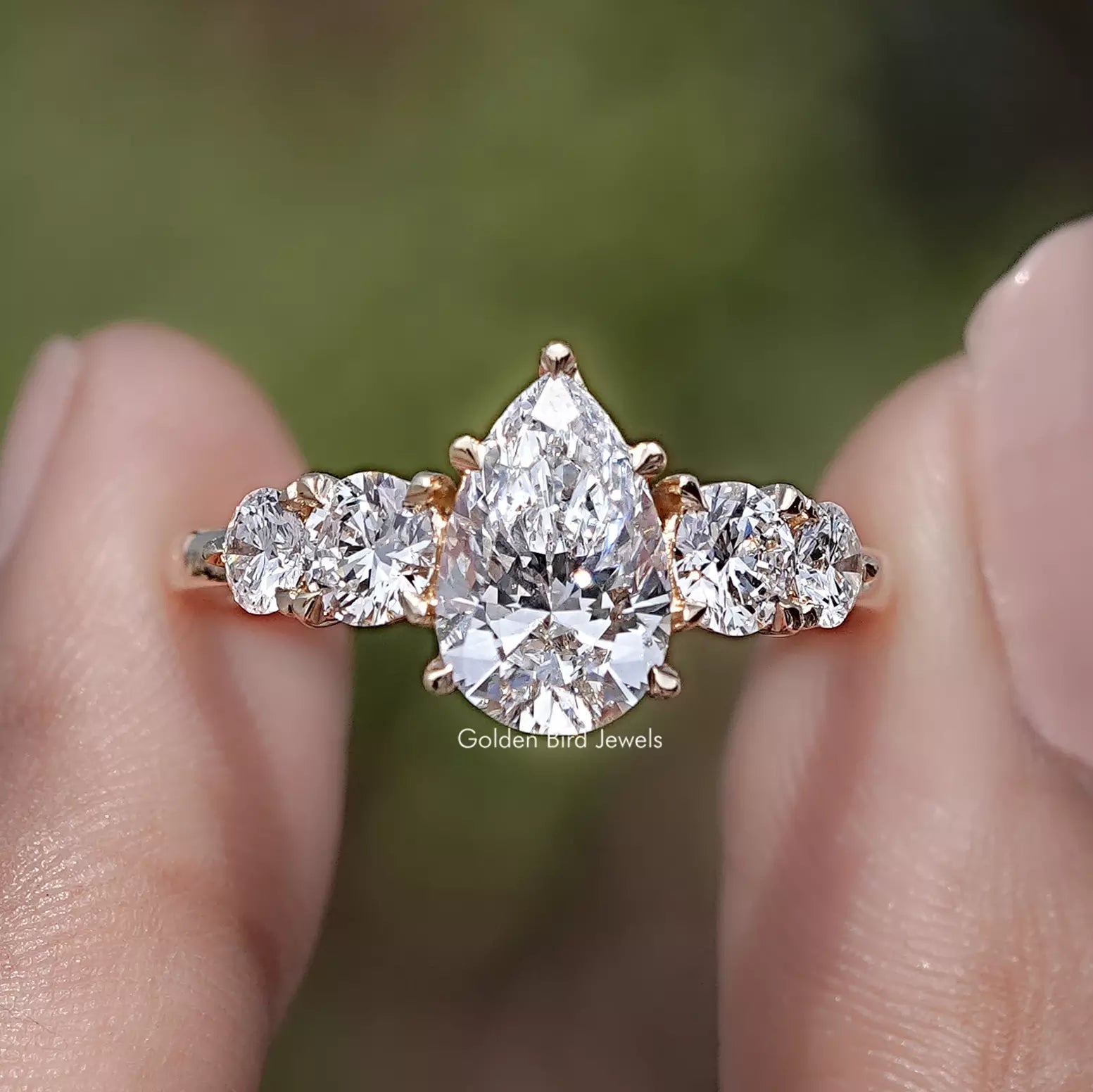 Pear Cut Lab Grown Diamond Five Stone Ring in Two Fingers