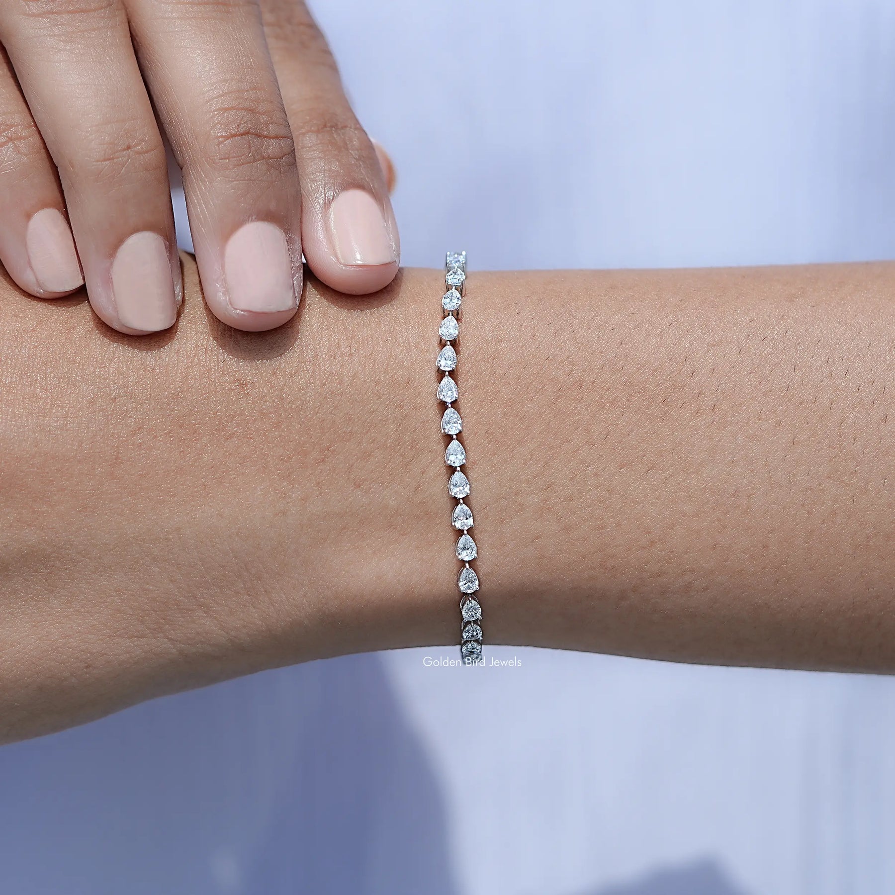 In hand Showing View Pear Cut Diamond Tennis Steel Bracelet
