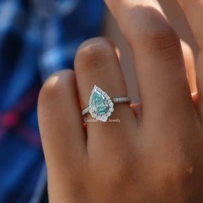 View of Moissanite Engagement Ring Made Of Pear Cut Stone In Finger