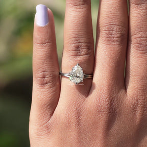 View of solitaire pear moissanite  ring in prongs setting 