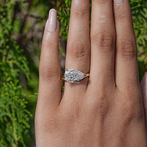 In finger view of Pear Lab Diamond Curved Solitaire Ring
