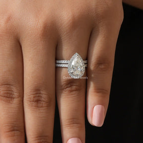 In Finger view of Pear Moissanite ring in white side stones 