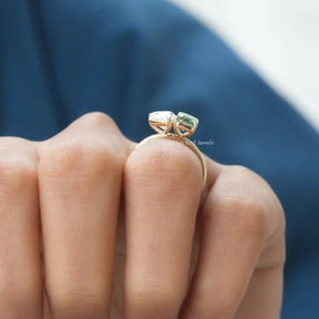 Side view of toi et moi pear and emerald shaped moissanite ring