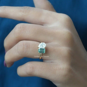 Stunning two-stone pear and emerald cut ring shown on finger