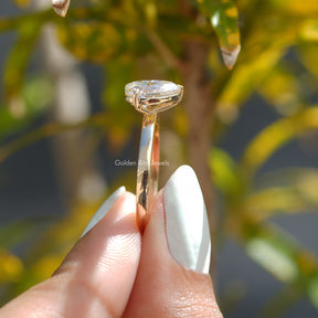 Side View of Pear And Princess Cut Toi Et Moi Ring In two fingers