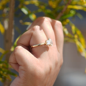 Close-Up View of Pear And Princess Cut Moissanite Ring In Yellow Gold
