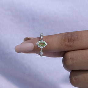 In finger front View of Oval Cut Gemstone Accent Stone Ring In White Gold