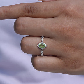Close-Up View of Peridot Green Oval Cut Accent Stone Ring In White Gold