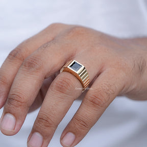 In finger front view of Black Gemstone Solitaire Men's Ring in unique shape