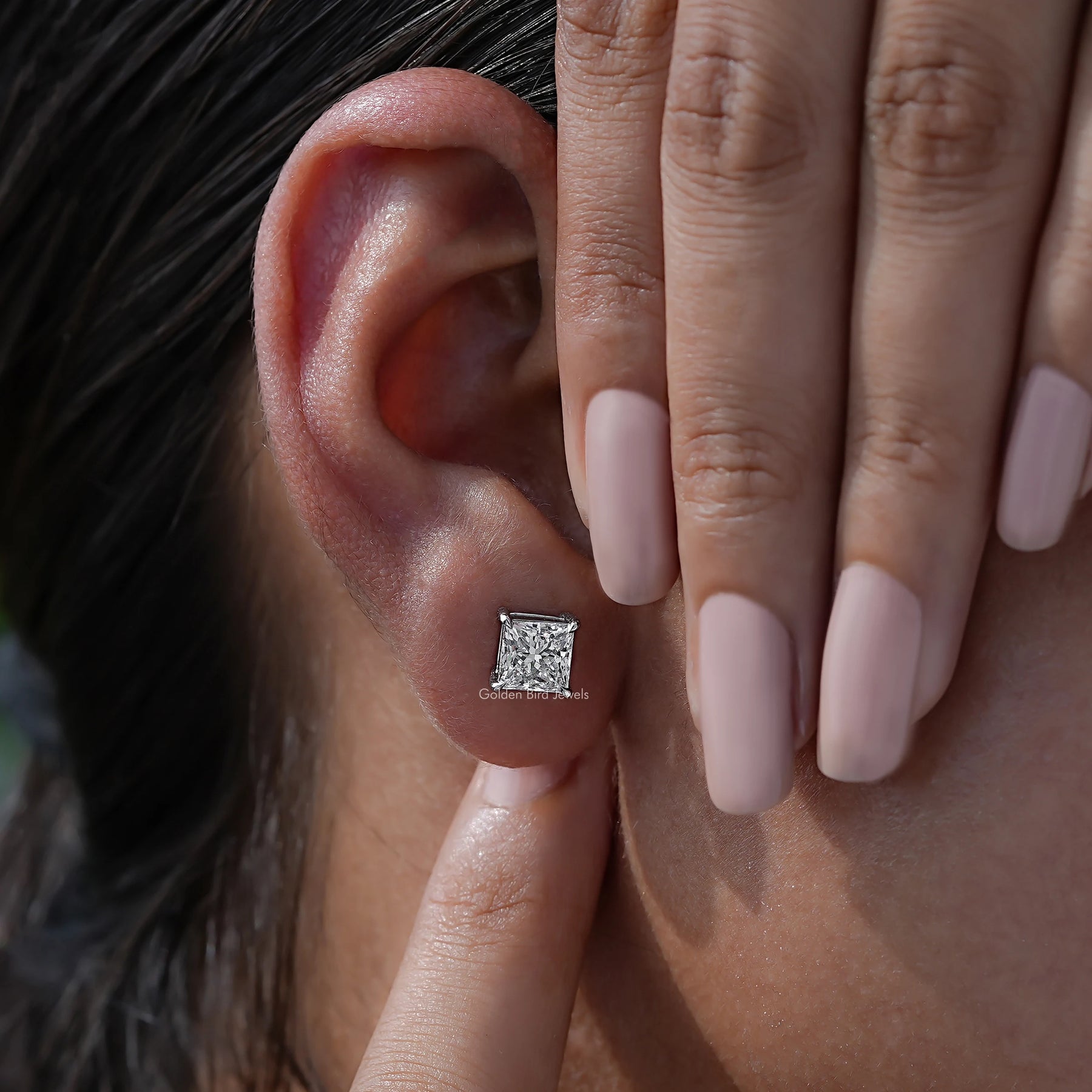 Close view of diamond stud earrings in a Unique design 