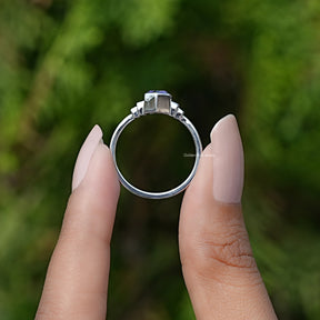 Back View of Amethyst Hexagon Cut Gemstone Ring In two fingers