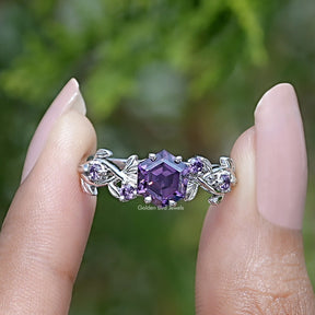 Two fingers holding the Purple Amethyst Hexagon Cut Engagement Ring
