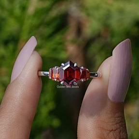Front View of Red Ruby Hexagon Cut Gemstone Ring In two Fingers
