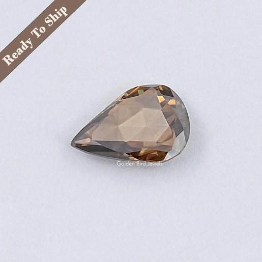 Pear-shaped rose-cut moissanite gemstone, faceted teardrop in champagne tones