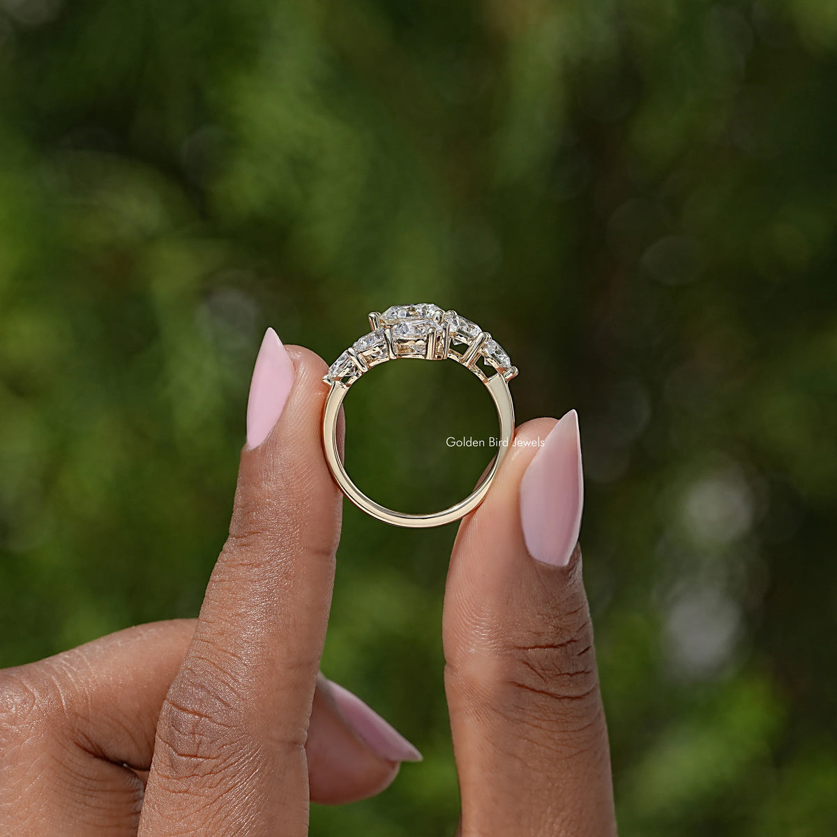 Round moissanite bypass ring, top view showing three stones and open shank