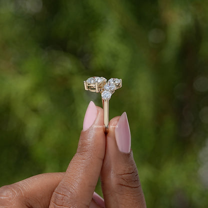 Gold-tone bypass shank ring with a cluster of round stones in a boxed setting