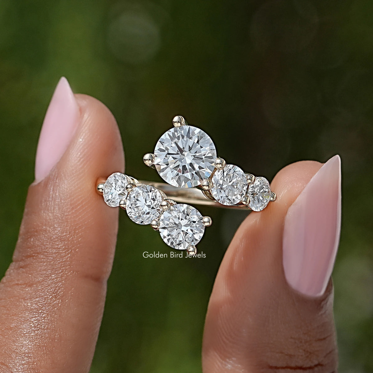 Bypass shank ring with three round moissanite stones in a silver-tone setting
