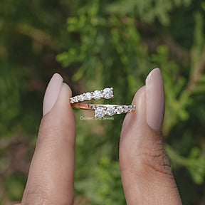 Front view of Round Cut Moissanite Open Wrap Bypass Ring in two fingers 