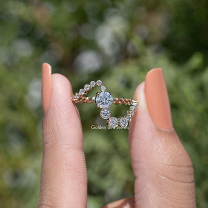 Gold wave wedding band with round moissanite-style stones set in a curved row